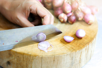 Sliced onions on the wooden cutting board.