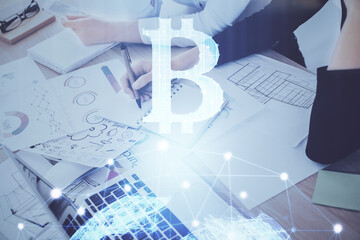 Cryptocurrency hologram over woman's hands writing background. Concept of blockchain. Multi exposure