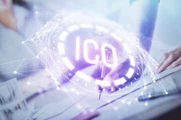 Cryptocurrency hologram over woman's hands writing background. Concept of blockchain. Multi exposure