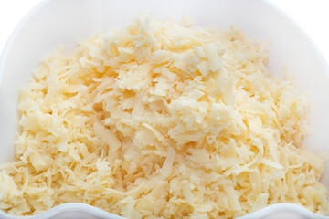Background with grated cheese in a plate