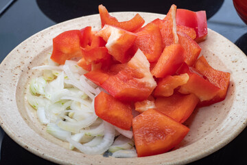 Sliced red pepper with onions on a plate