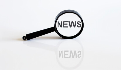 Magnifier with text NEWS on the white background