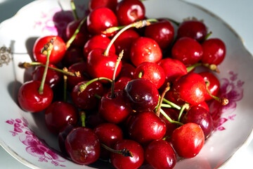 red sweet cherry lies on a plate
