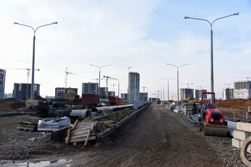 Road repair works at construction site. Construction road of city street  in a new residential...