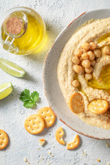 Enjoy your hummus with crackersi, coriander and lime