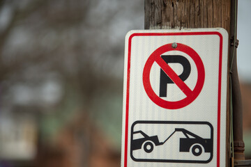 no parking tow sign on a street post