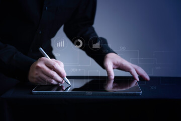 Closeup Businessman hand writing on digital tablet with marketing icon graphic with copy space, Smart digital business and ecommerce concept