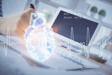 Heart hologram over woman's hands writing background. Concept of Medical study. Multi exposure