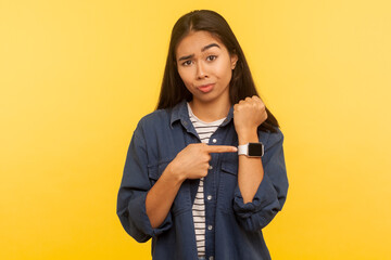 Time to go, hurry up! Portrait of displeased angry woman in denim shirt looking impatient and...