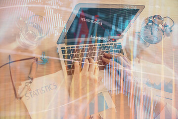 Multi exposure of forex graph with man working on computer on background. Concept of market analysis.