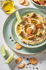 Traditional hummus with crackers and pumpkin seeds