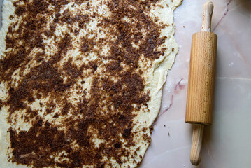 Cinnamon roll baking. Homemade cake.