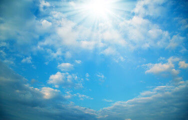 Naklejka na ściany i meble Blue cloudy sky with sun