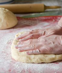 Hands kneading dough