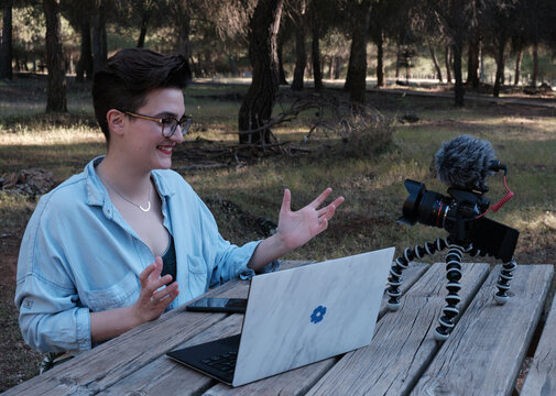 Young Woman And Youtuber Talks To The Camera Smiling.