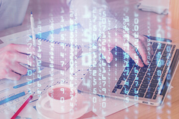 Double exposure of data internet theme hologram with man working on computer on background. Concept of innovation.