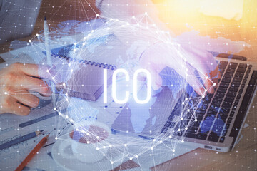 Crypto currency theme hologram with businessman working on computer on background. Concept of...
