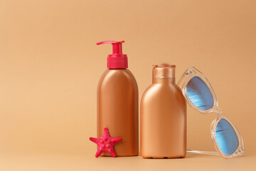 Facial and body skin care on the beach, at sea, on summer vacation. Safe tan set with sunglasses pink and starfish.