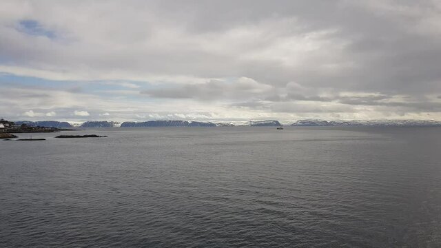 mighty sea and snowy mountain view sailing a ship in Finnmark, northern Norway