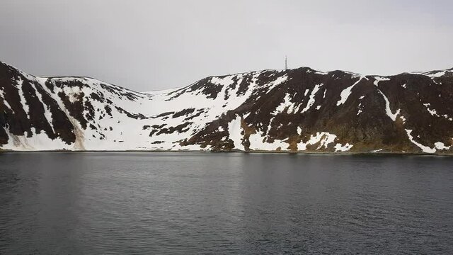 mighty snowy mountain sailing out from Honningsvaag, northern Norway