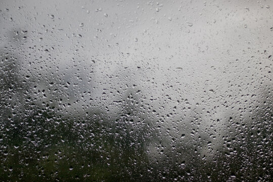 raindrops on the window - view out the window outwards, rainy weather, texture background