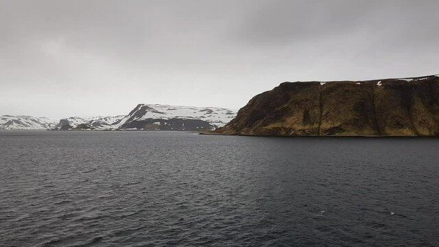 mighty sea and snowy mountain view sailing a ship in Finnmark, northern Norway
