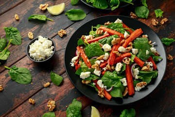 Roasted carrot salad with feta cheese, walnut and spinach. healthy food
