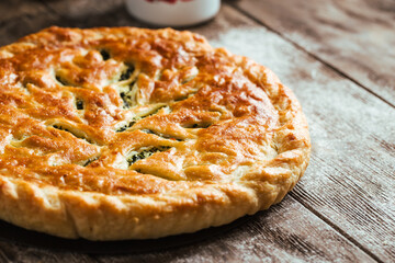 Fresh baked pie with spinach and cheese filling