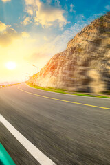 Motion blurred road and mountains at sunrise.mountain road background.