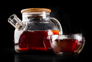 tea pot and Cup of puer tea on black background
