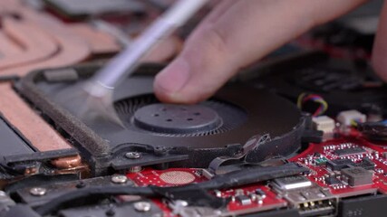 man cleans a laptop with a brush for blowing dust cooling system. Repair and service laptops and PC Advertisement of repair service for electronics and devices