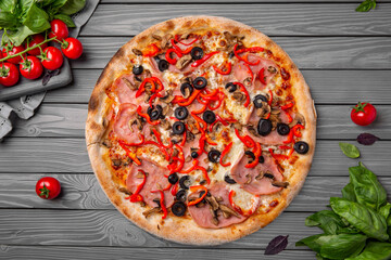Tasty hot italian pizza with ham, sweet pepper, olives. Pizzeria menu. Concept poster for Restaurants or pizzerias. Top view