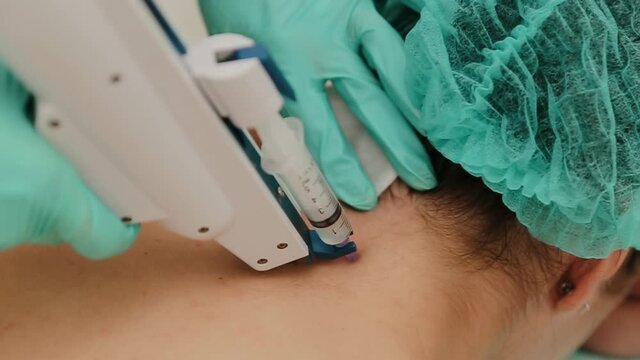 The mesotherapy procedure in process. Beautician doing injection with mesotherapy gun against aging for women. Injects into neck. Skin care.