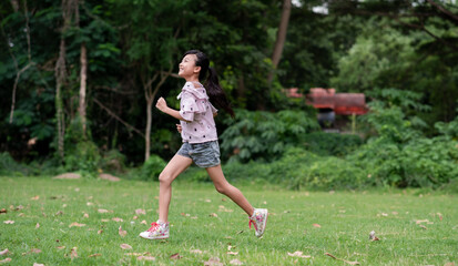 A girl  Asian running on open grasslands