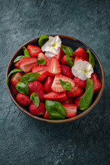 Diet vegetarian salad with strawberries and basil.