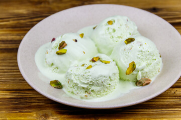 Pistachio ice cream on wooden table