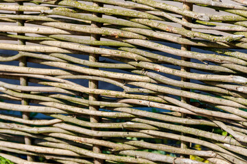 Background of the decorative rustic village wicker fence