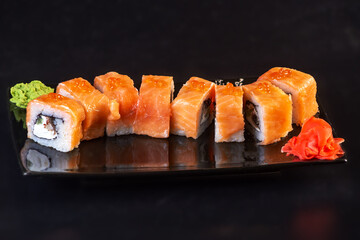 rice rolls on a black plate on a dark background asian menu