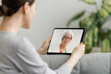 woman is using tablet pc for remote conversation with friends