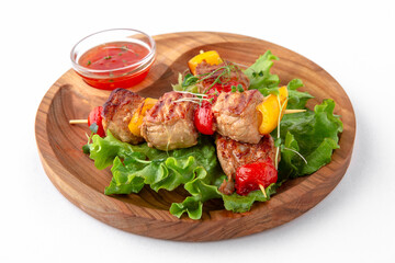 Meat skewers of juicy pork with sauce. Banquet festive dishes. Gourmet restaurant menu. White background.