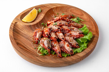 Prawns fried in soy sauce with garlic. Banquet festive dishes. Gourmet restaurant menu. White background.