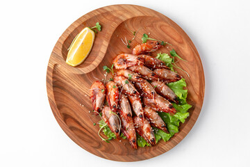 Prawns fried in soy sauce with garlic. Banquet festive dishes. Gourmet restaurant menu. White background.