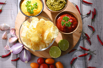 Composition with bowl of potato chips.