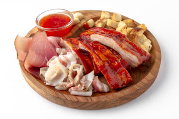 Smoked pork ribs in the glaze, lard, crackers with garlic. Snack for beer or vodka. Banquet festive dishes on white