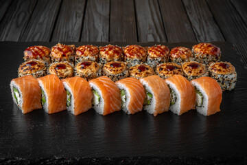 Sushi set. Philadelphia roll, california, unagi, black dragon with fresh ingredients on black background. Sushi menu. Japanese food. 