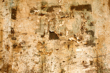 Texture and faded and peeling paint on a section of timber