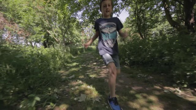Young boy running and playing outdoors. Corona-virus, covid-19 lockdown restrictions eased within UK. Filmed Yorkshire, England, UK. 
