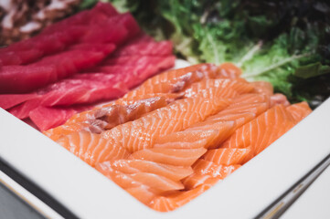 Salmon and tuna sashimi in a white tray