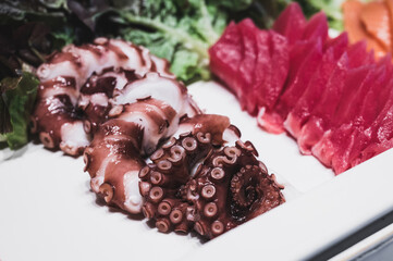 Octopus and tuna sashimi in a white tray