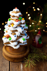 Baked gingerbread christmas tree on wooden background. Close-up
